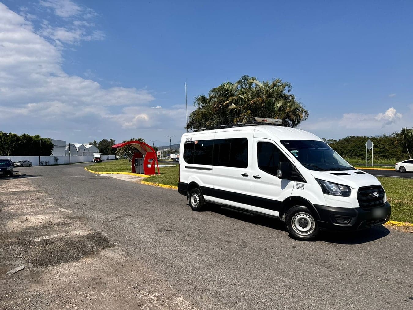 Ford Transit de pasajeros blanca vista de tres cuartos en calle abierta